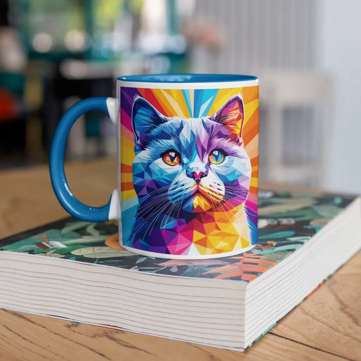 Colorful mug with a cat design on a stack of books