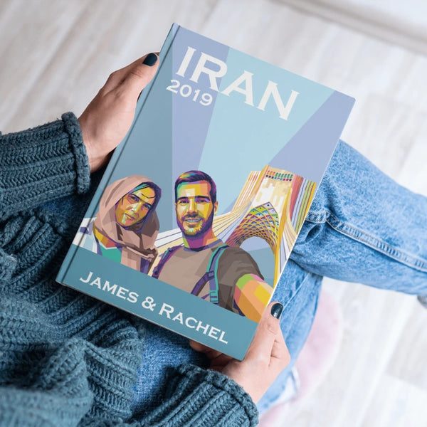 Book titled 'Iran 2019' held by a person with a colorful cover design.