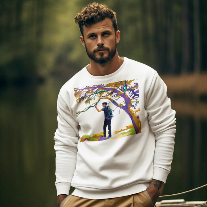 Man wearing a white sweatshirt with a colorful graphic design outdoors.