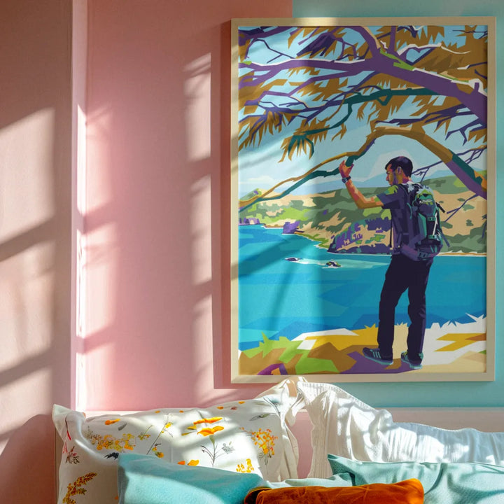 Framed artwork of a person fishing by a lake on a wall with pink and blue tones.