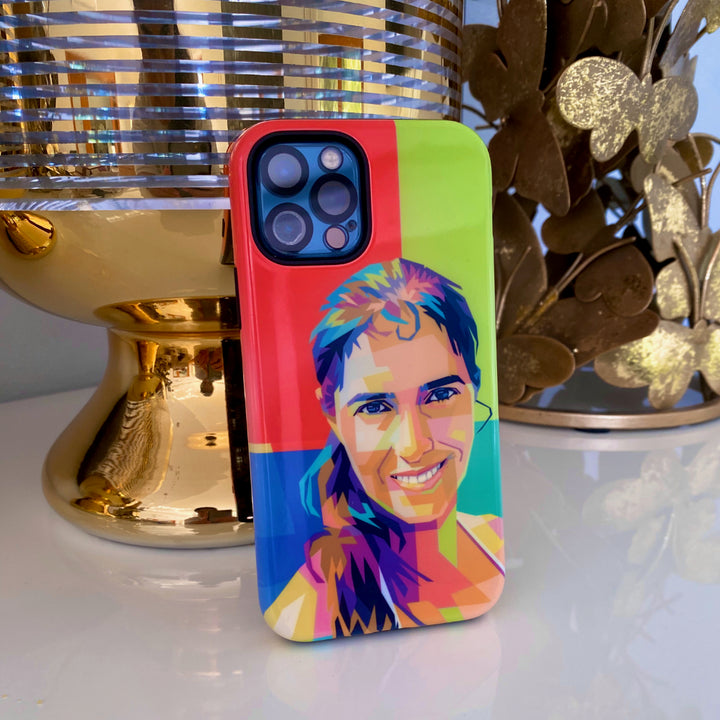 Colorful phone case with a stylized portrait design on a reflective surface.